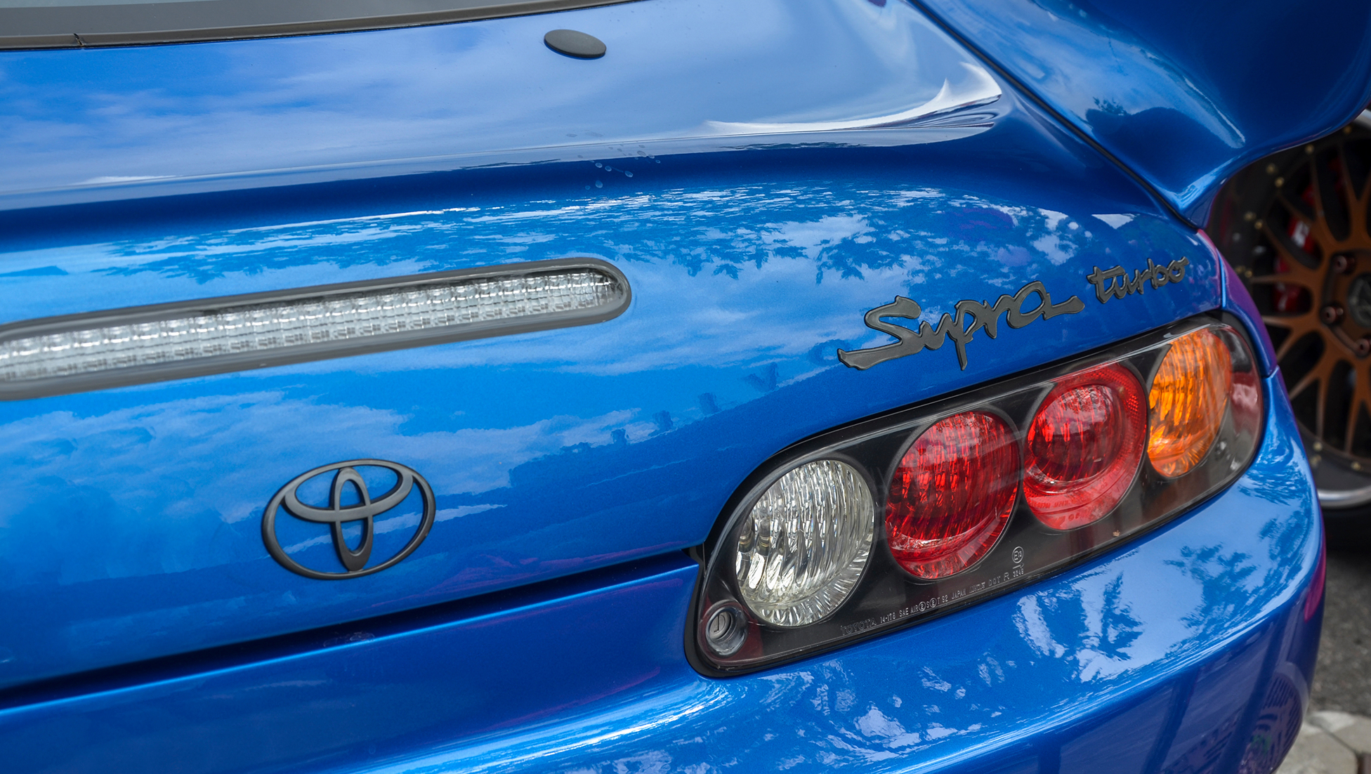 Rear detail of a blue Toyota Supra Turbo Mk4 showing iconic taillights and Supra Turbo badge